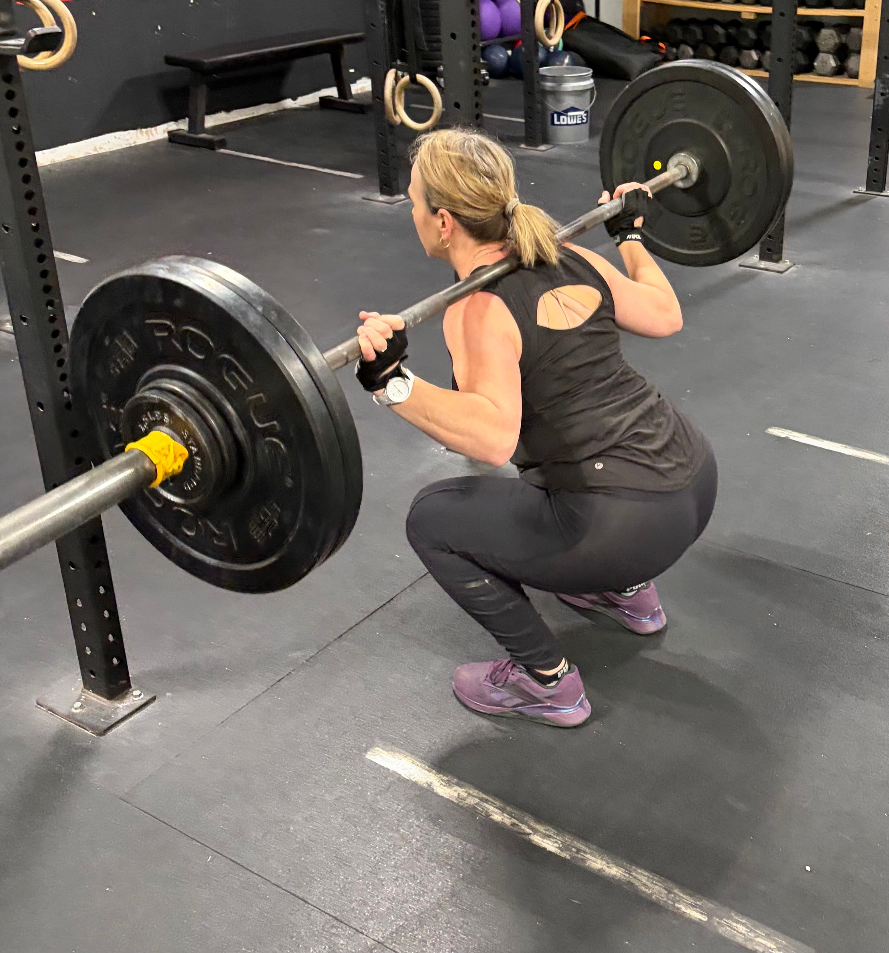 Client squatting a barbell